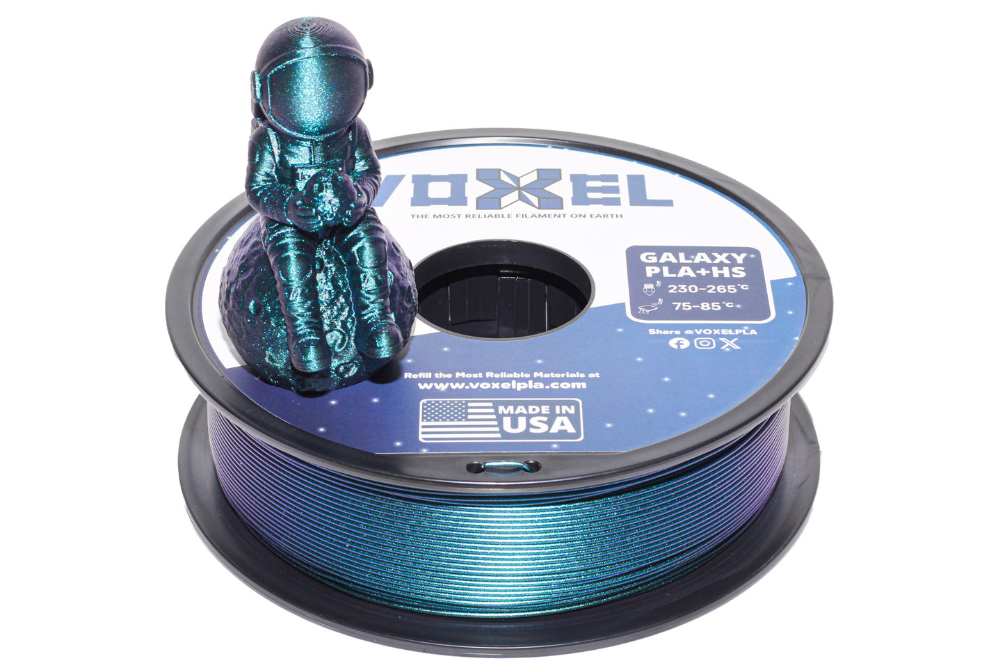A spool of Voxel Galaxy PLA-Re 3D printer filament with a small figurine of an astronaut sitting on top, shown against a plain white background.